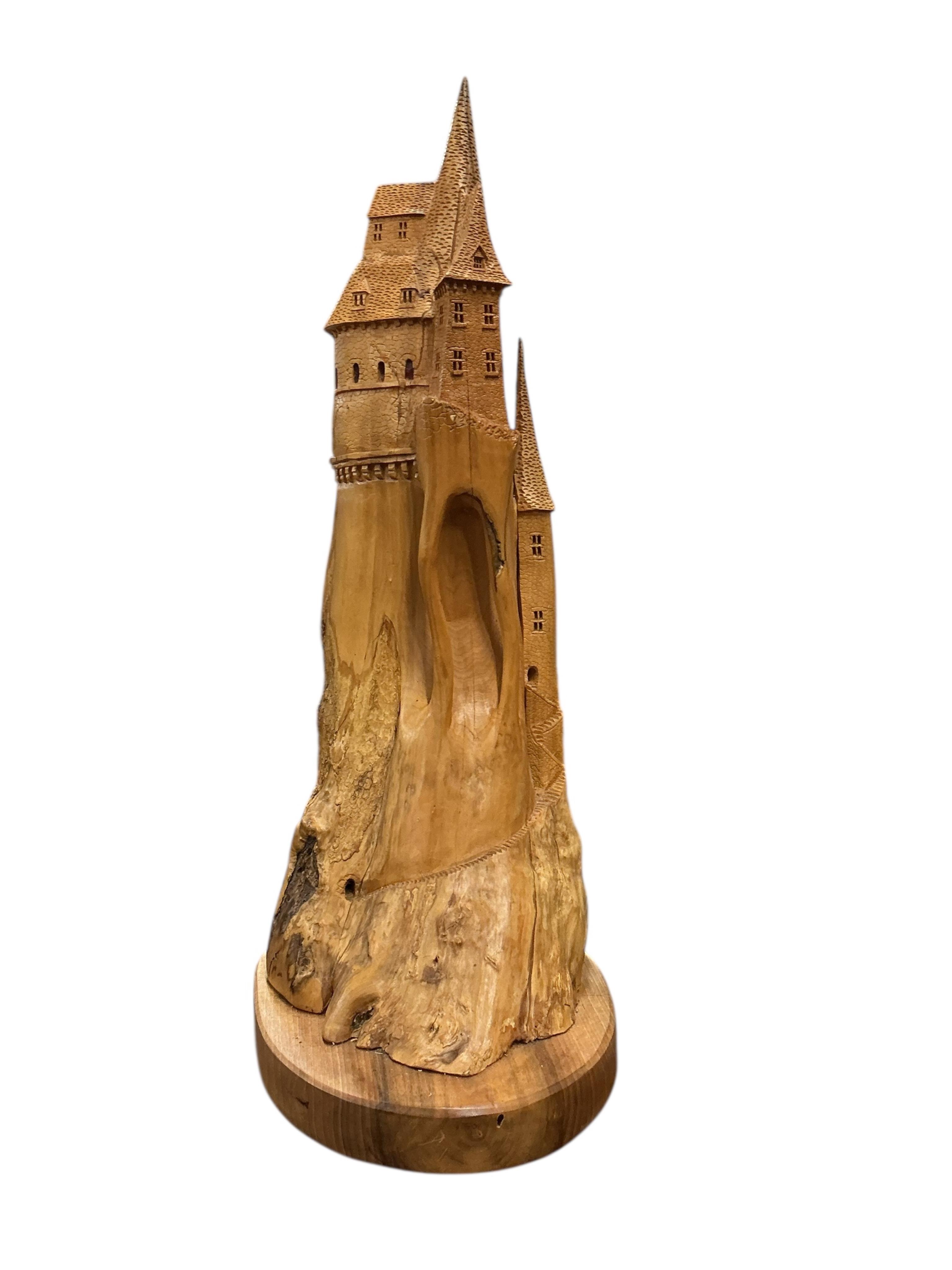 Pierre Decorse (b.1953), a naturalistically modelled sculpture of a fairytale castle emanating from rocks, height 84cm